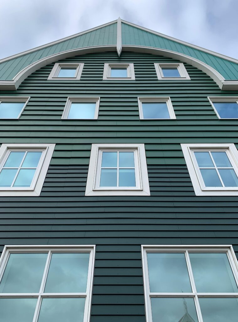 Low-angle view of a green building facade in Zaandam, Netherlands, showcasing modern Dutch architecture.