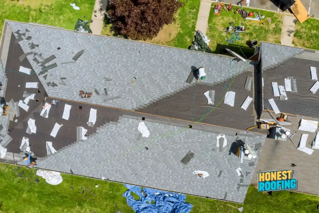 Emergency roof repair Pennsylvania — aerial view of residential roof mid-replacement with Honest Roofing crew on site